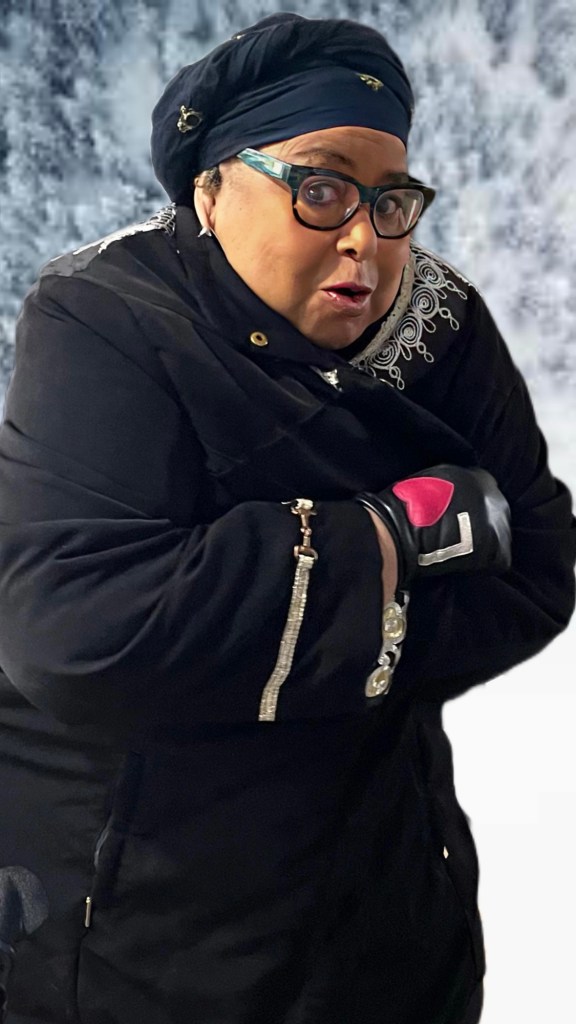 Images of my mother modeling her black coat with silver and gold metallic decorations while standing outside in the snow.