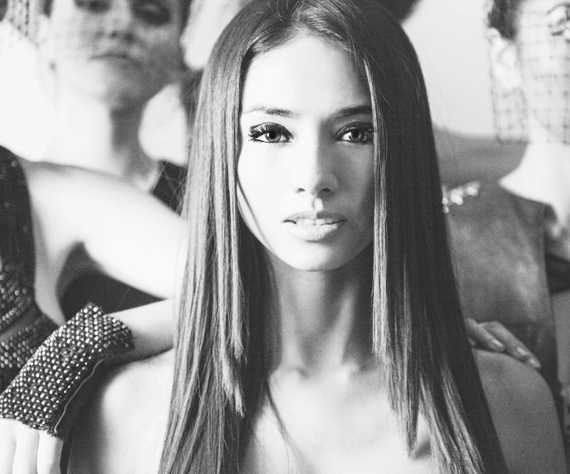 Coral Castillo headshot in black and white surrounded by models.